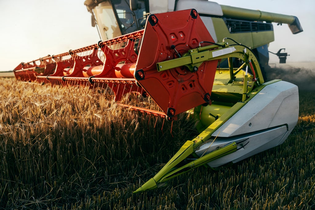 Modern combine harvester with a cutting header harvesting a field.