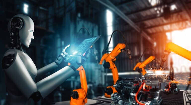A humanoid robot using a tablet to control robotic arms in an advanced manufacturing facility.