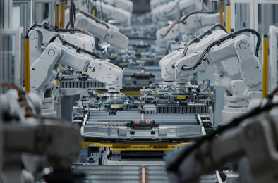 Robotic arms assembling components on a production line.